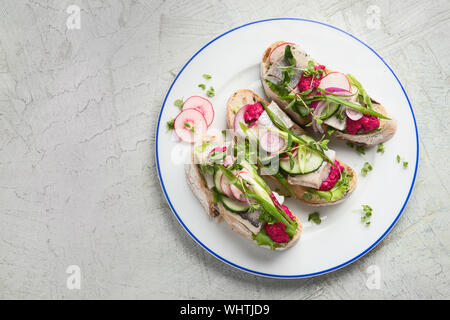 Smorrebrod, traditional Danish open face sanwiches on grey background. top view with copy space Stock Photo