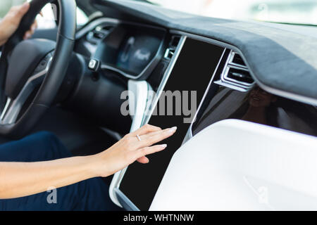 Woman driving car in the morning using navigator Stock Photo