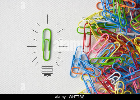 Individuality symbol and independent thinker concept and new leadership concept or individuality as a group of paperclip on canvas with one individual Stock Photo