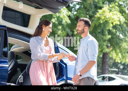 Bearded loving husband meeting his wife near car Stock Photo