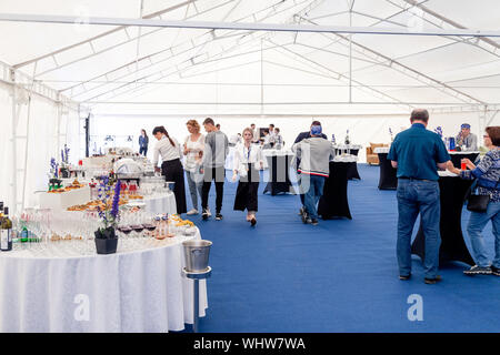 Russia Kemerovo 2019-07-27 People at catering stand-up meal party, waiters, guests on banquet, table setting, wine glasses, snacks, alcohol, plates Stock Photo