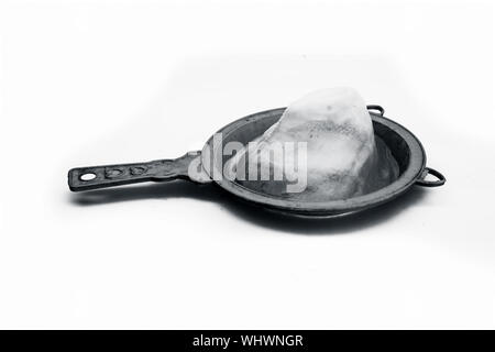Close up of yellow plastic strainer or sieve isolated on white. Stock Photo