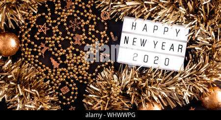 Happy new year lightbox on black table background.top view of tinsel,ball ,ornament party decorate on tabletop.holiday celebration greeting card Stock Photo