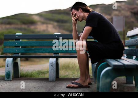 Depressing scene. Outdoor park bench Stock Photo