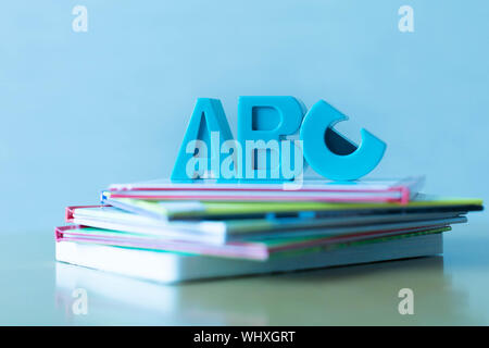 Closeup of books with plastic A,B, and C letters in blue tinted style Stock Photo