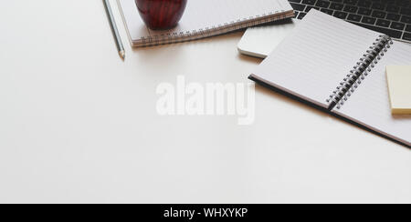 Open notebook and office supplies on white table desk background in modern workplace style Stock Photo