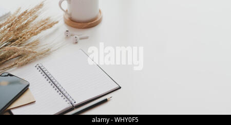 Open notebook and office supplies on white table desk background in minimal workplace style Stock Photo