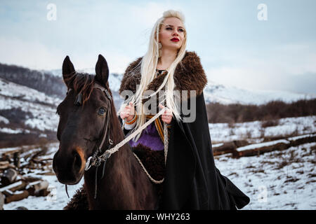 Beautiful black crow, Viking blonde woman with shield and sword, braids