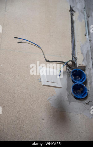 Replacing the electrical outlet in the wall of the house. Stock Photo