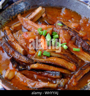 High view homemade Vietnamese vegetarian food on circle plate, banana flower vegan fish cook with soy sauce, coconut and tomato, delicious dish Stock Photo