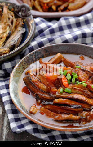 High view homemade Vietnamese vegetarian food on circle plate, banana flower vegan fish cook with soy sauce, coconut and tomato, delicious dish Stock Photo