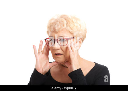 An old lady expresses shock/ surprise. Isolated on white. Stock Photo
