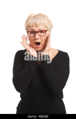 An old lady expresses shock/ surprise. Isolated on white. Stock Photo