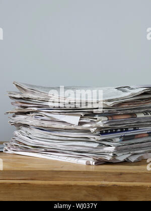 Stack of newspapers on table Stock Photo