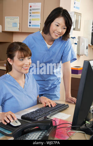 Two female nurses working on computer in doctor's office Stock Photo