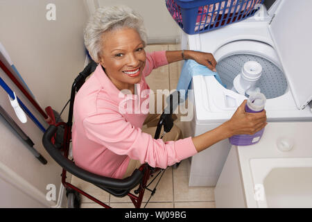 Woman doing laundry at home Stock Photo