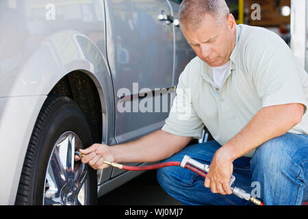 Man Filling Tires on RV Stock Photo
