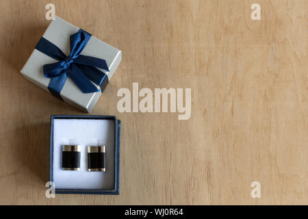 Download Pair Of Cufflinks In A Gift Box On Wooden Background Copy Space Mockup For Design Stock Photo Alamy