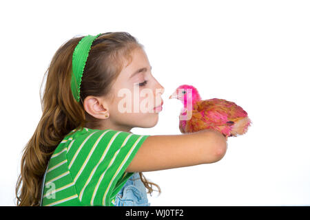 breeder hens kid girl rancher farmer kissing a chicken chick white background Stock Photo
