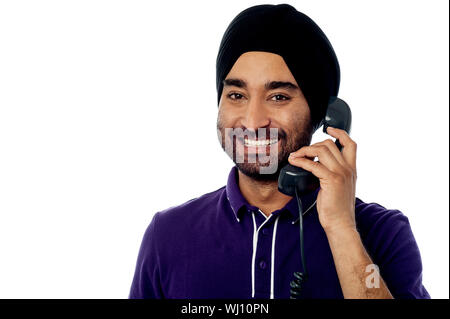 Handsome young guy attending phone call Stock Photo