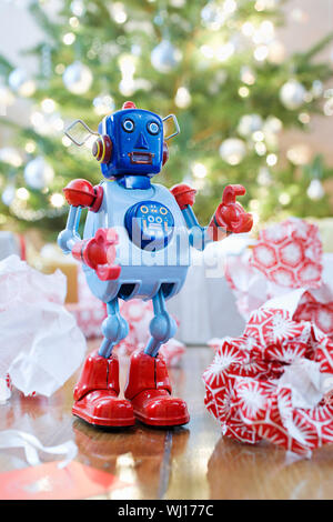 Retro style toy robot in front of Christmas tree Stock Photo