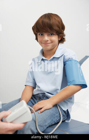 Boy having blood presure taken Stock Photo