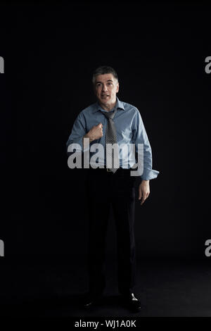 Full length of businessman pointing himself isolated over black background Stock Photo
