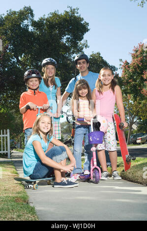 Full length portrait of children with scooters and skateboard Stock Photo