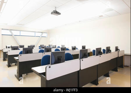 View of empty chairs and computers in rows at seminar room Stock Photo