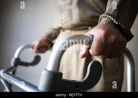 Closeup midsection of a man using walking frame Stock Photo