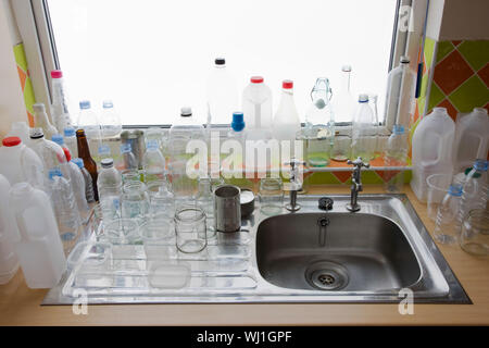 Closeup of clean bottles at kitchen sink in house Stock Photo