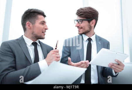 young businesspeople looking at each other and talking at the office Stock Photo