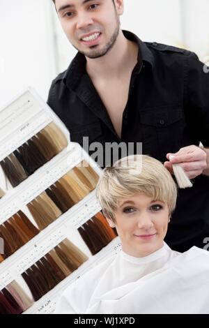 Hairdresser suggesting hair shades to customer Stock Photo