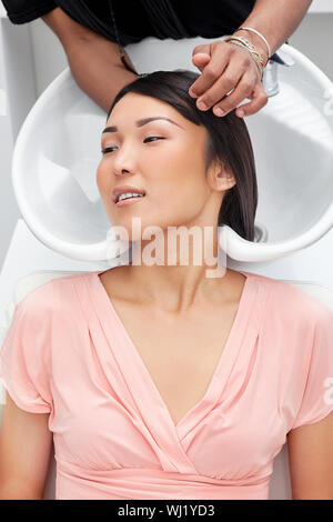 Asian woman having hair wash at beauty salon Stock Photo