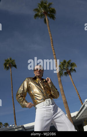 Low angle view of middle-aged man impersonating Elvis Presley Stock Photo