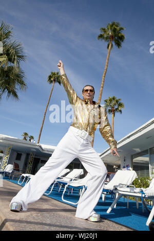 Low angle view of man impersonating Elvis Presley Stock Photo