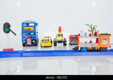 Toy cars waiting at railway crossing Stock Photo