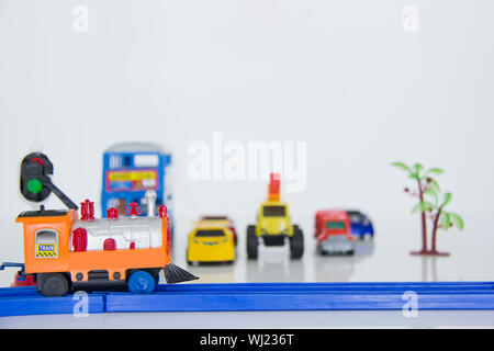 Toy cars waiting at railway crossing Stock Photo