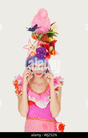Portrait of beautiful young woman in Brazilian outfit over gray background Stock Photo