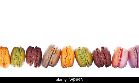 Row of pastel colored french macarons, on white background Stock Photo
