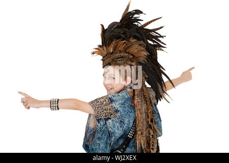 Portrait of boy in costume with headdress looking back over white background Stock Photo