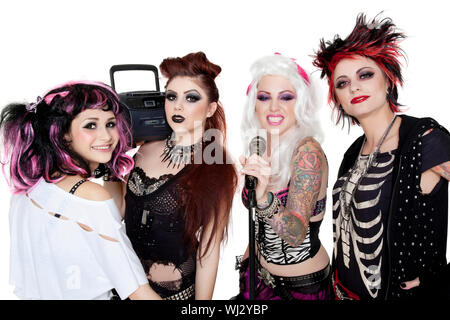 Portrait of all female band with microphone and boom box over white background Stock Photo