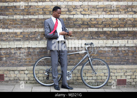 Portrait of African American businessman with Bicycle Stock Photo