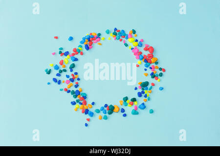 Colorfull sea stones polished in circle frame on blue background. Flat lay, top view, copy space Stock Photo