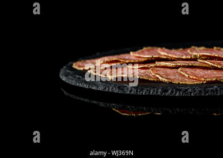 delicious sliced sausages on stone board. copy space Stock Photo
