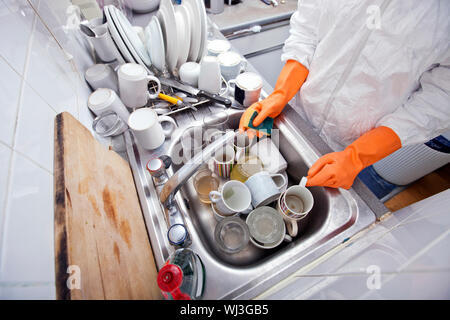 Midsection of woman washing utensil at kitchen sink Stock Photo