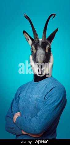 Head of a Goat on a man's body Stock Photo