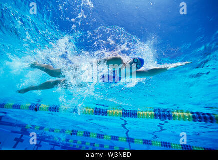 Female swimmer in United States swimsuit while swimming in pool Stock Photo