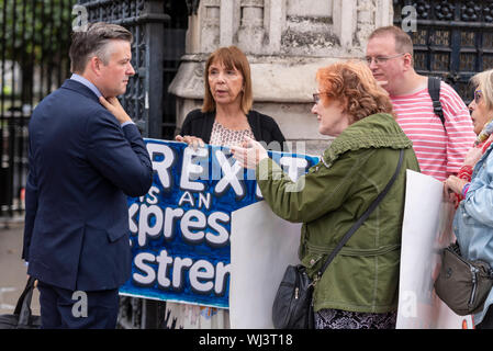 MPs have begun arriving at the Palace of Westminster to resume duties after the summer recess, at least until the prorogue of Parliament next week. Protesters have gathered against and in favour of both Brexit and Boris Johnson's decision to suspend Parliament. Labour MP Jonathan Ashworth discussing Brexit with protesters Stock Photo