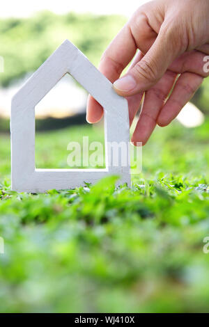 Human hands holding model of dream house Stock Photo - Alamy